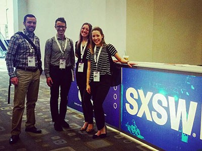 Jeff Hyslop, Brian Love, Jenni Lachner and Lauren Scranton standing by SXSW sign